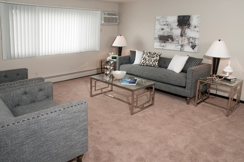 a living room with couches and chairs and a coffee table