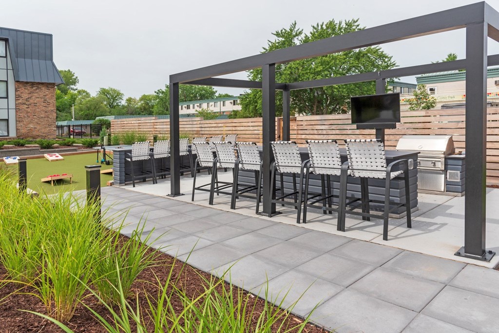 a patio with a table and chairs and a television