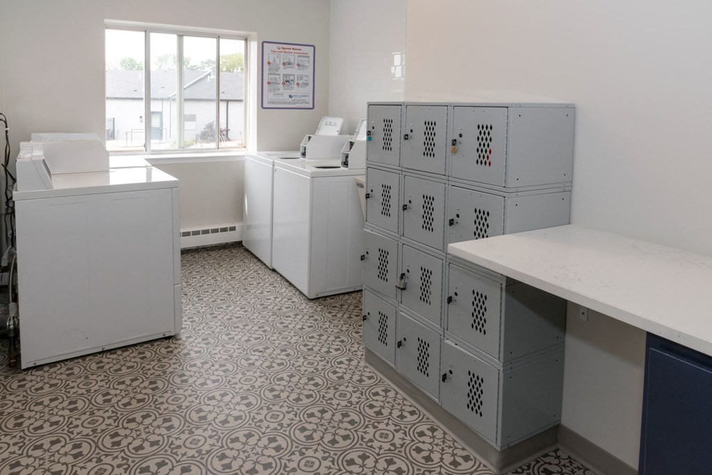 a room with white cabinets and a window