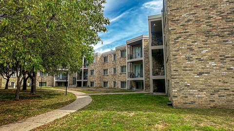 A modern building with a brick facade and a pathway leading to it.