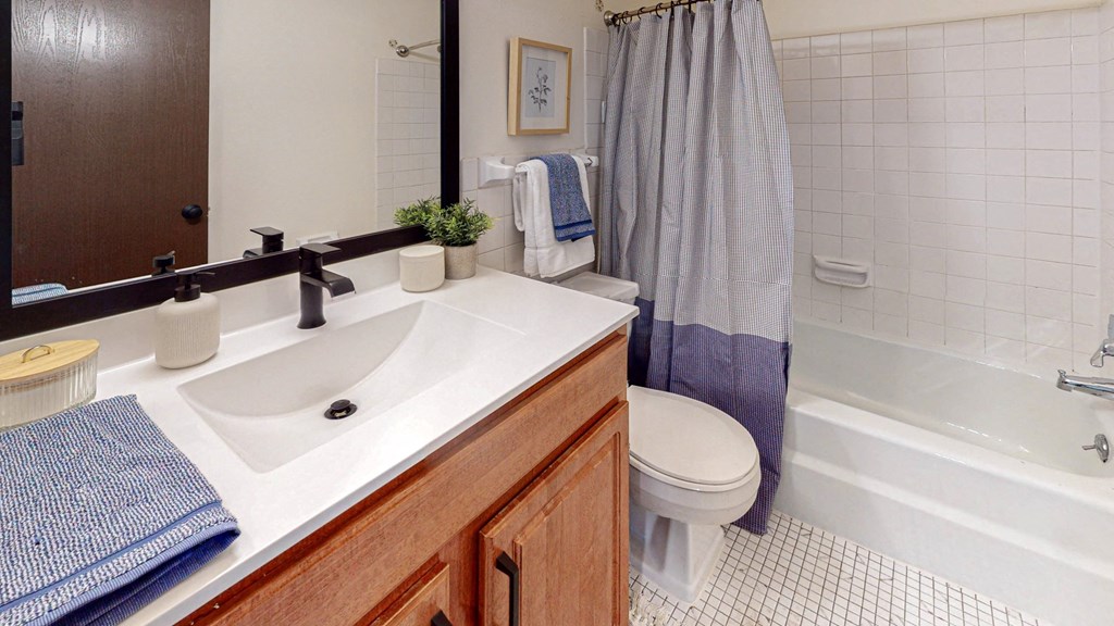 Bathroom with large vanity at Hillsborough Apartments.