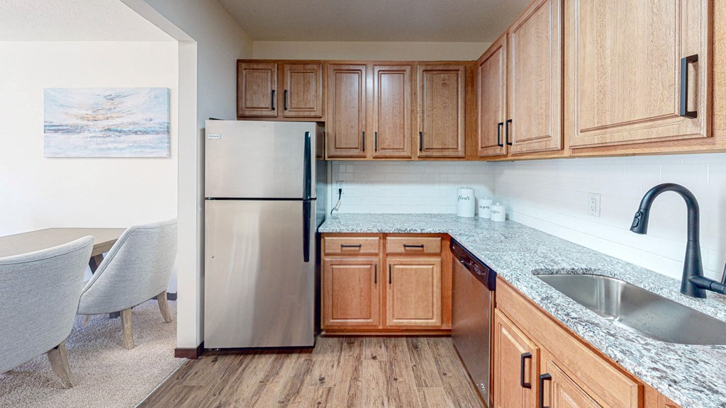 Kitchen opens to the dining area in our spacious apartment homes in Roseville. at Hillsborough Apartments, Roseville, MN, 55113