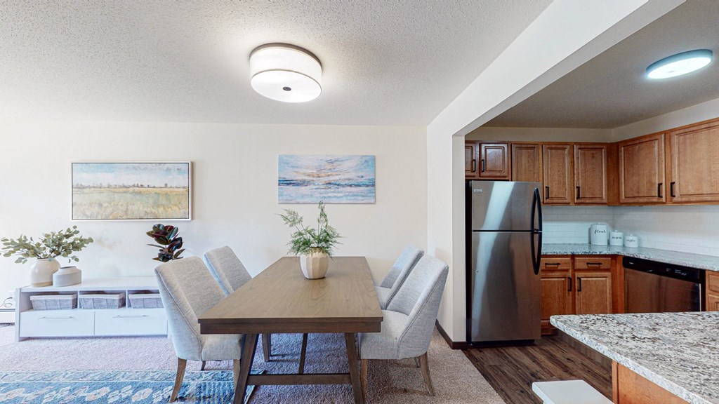 Kitchen opens to the dining area in our spacious apartment homes in Roseville. at Hillsborough Apartments, Minnesota