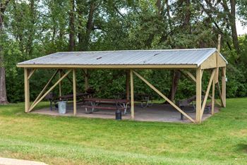 a pavilion with a picnic table in a park
