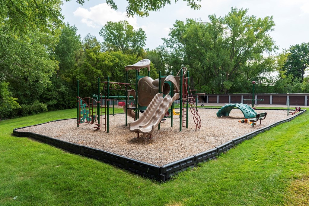 a playground with slides and other equipment in a park