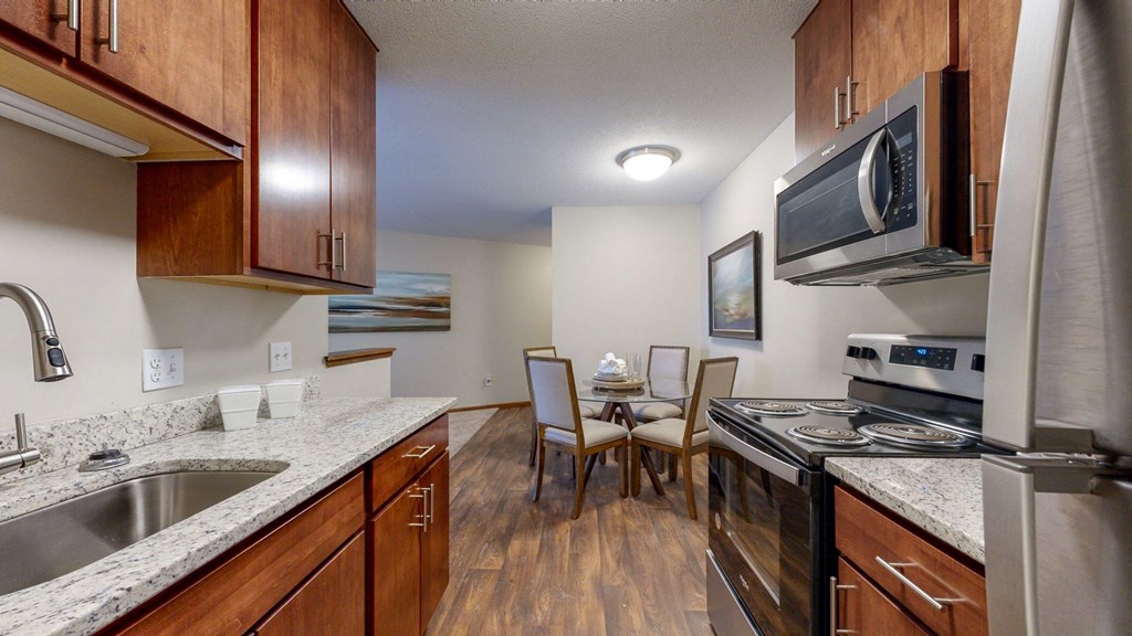 a kitchen with wooden cabinets and granite countertops