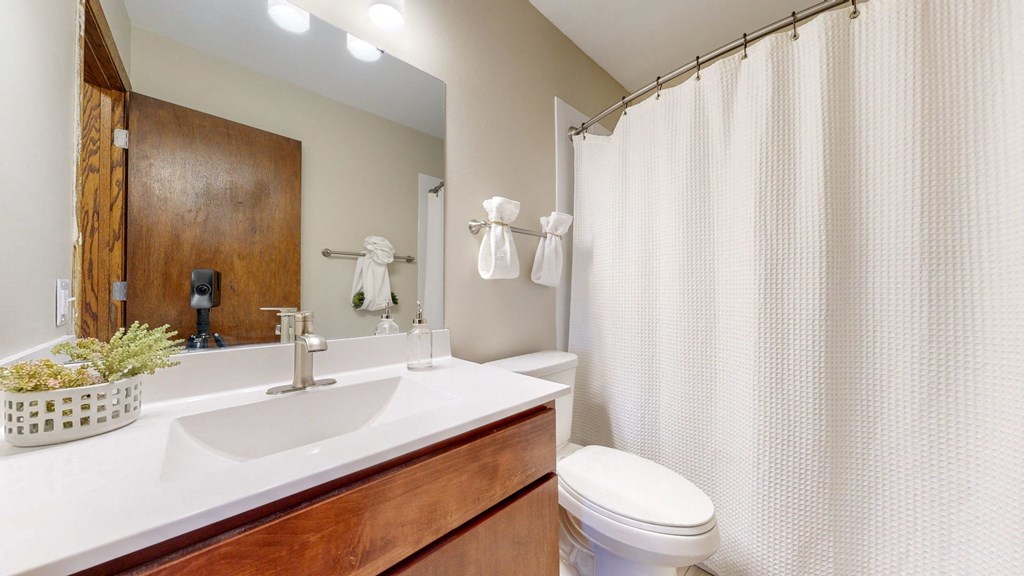 a bathroom with a sink toilet and shower