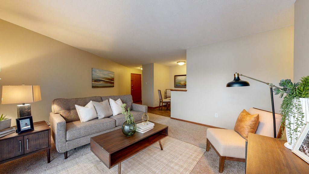 a living room with a gray couch and a wooden coffee table
