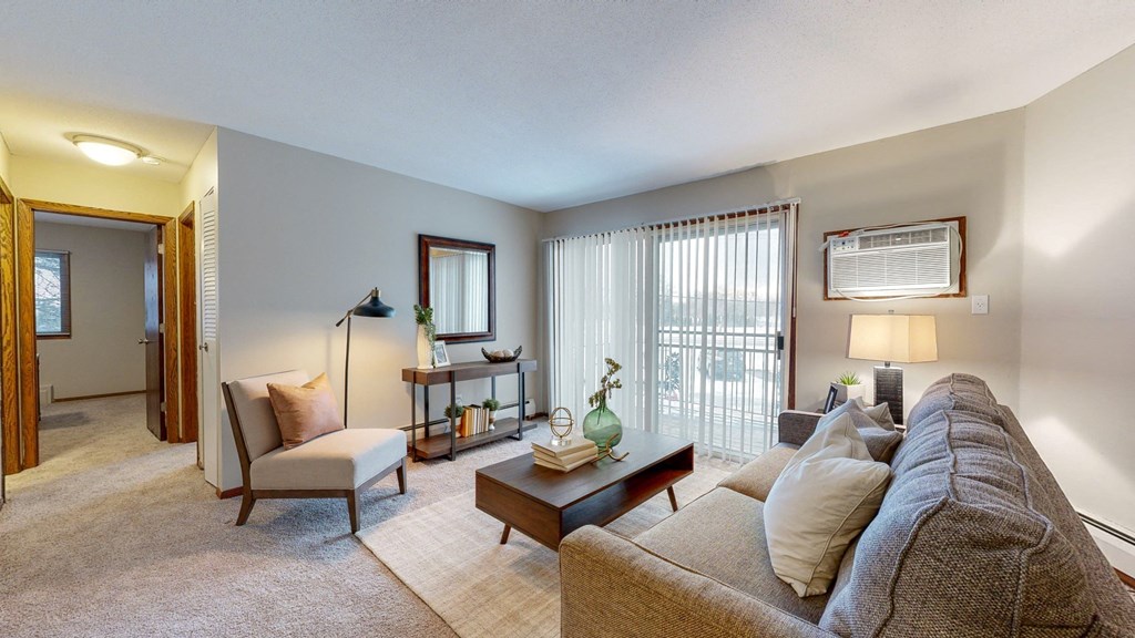 a living room with a couch chair and coffee table