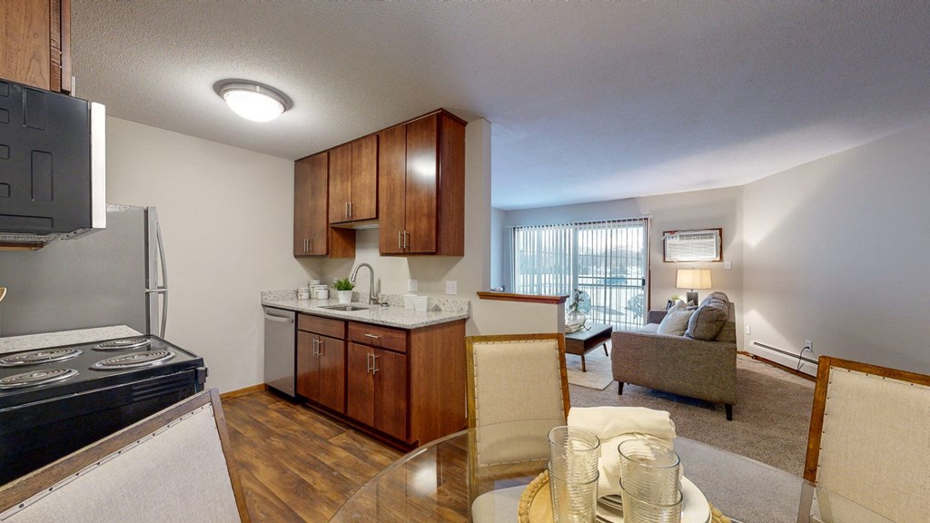 a kitchen and living room with a view of the balcony