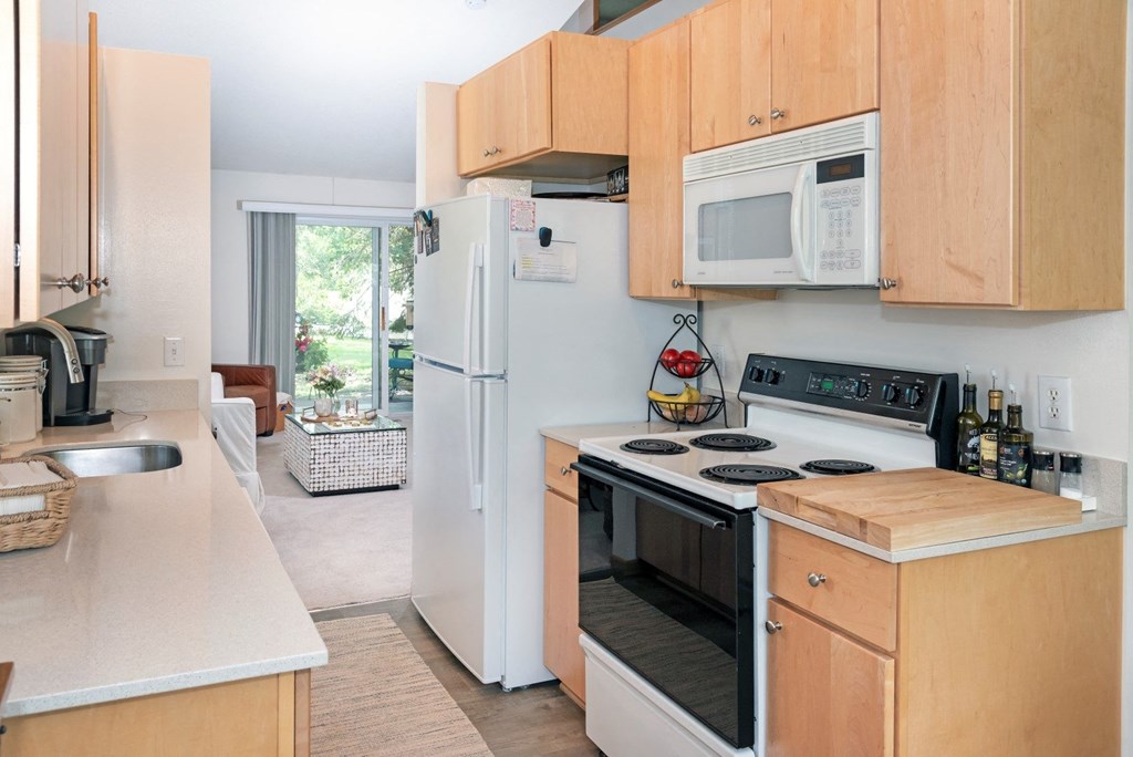a kitchen with wooden cabinets and white appliances