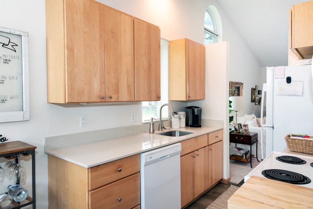 a kitchen with wooden cabinets and white appliances