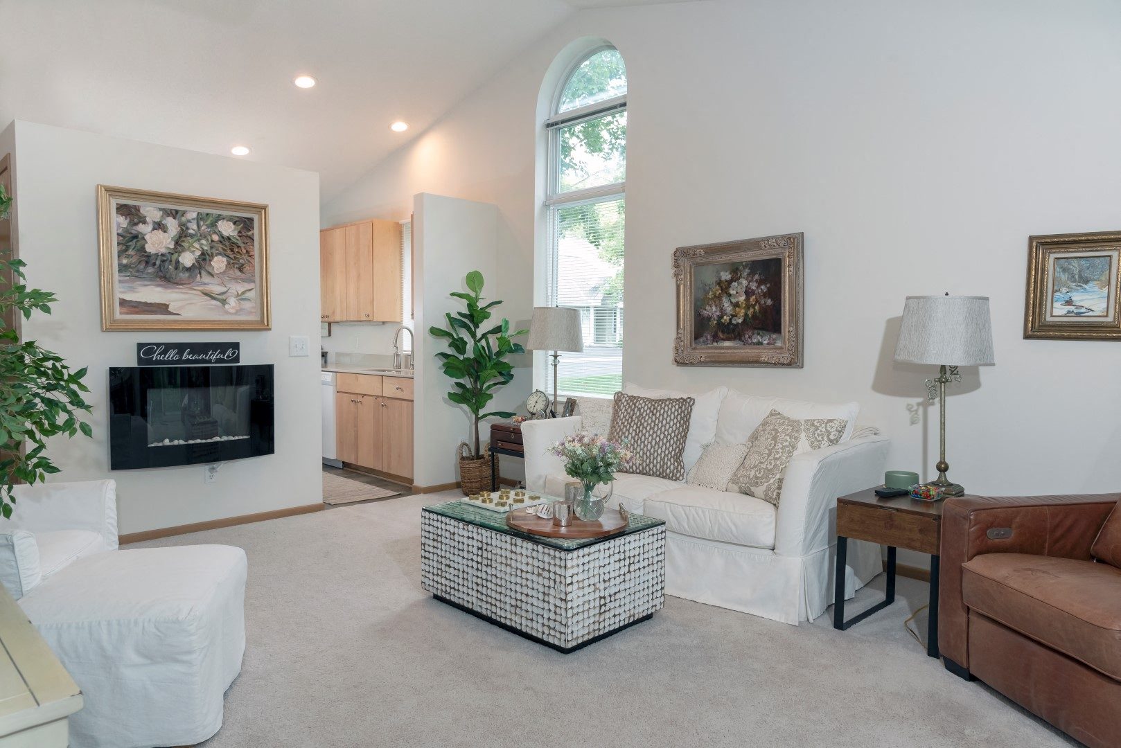 a living room with a white couch and a fireplace