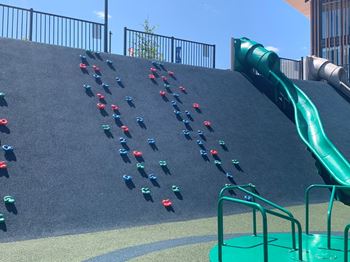 a climbing wall with colorful cups on it