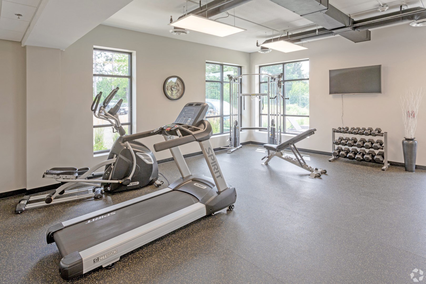 the gym with treadmills and other exercise equipment at the belgard apartments