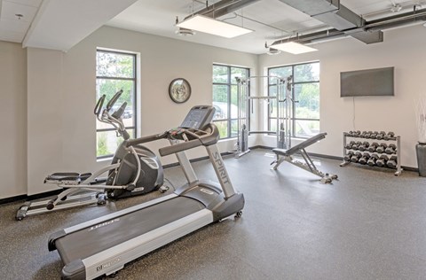 the gym with treadmills and other exercise equipment at the belgard apartments