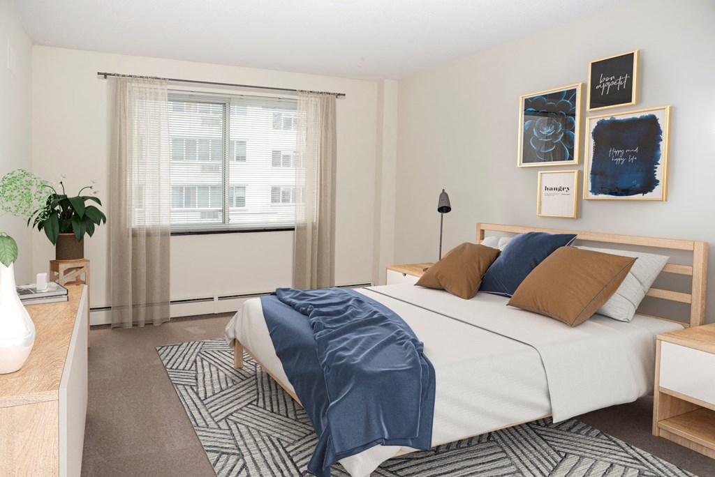 a bedroom with a bed and pictures on the wall