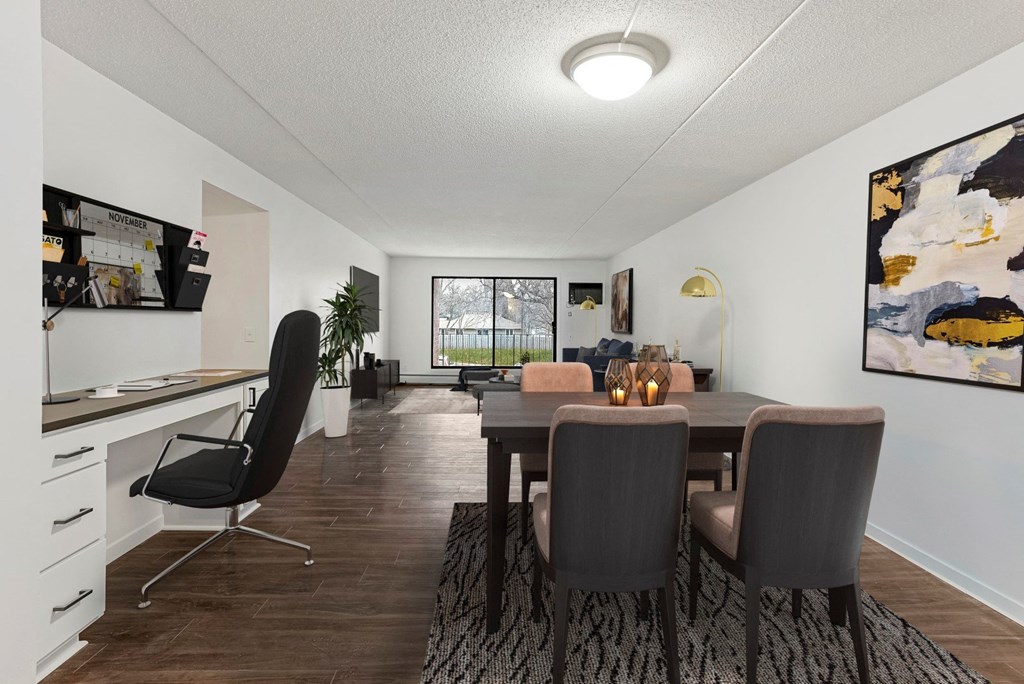 the living room and dining room with a table and chairs