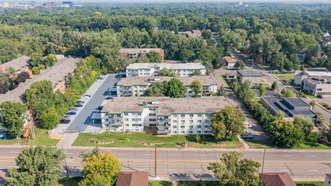 A large white building with a parking lot in front of it.