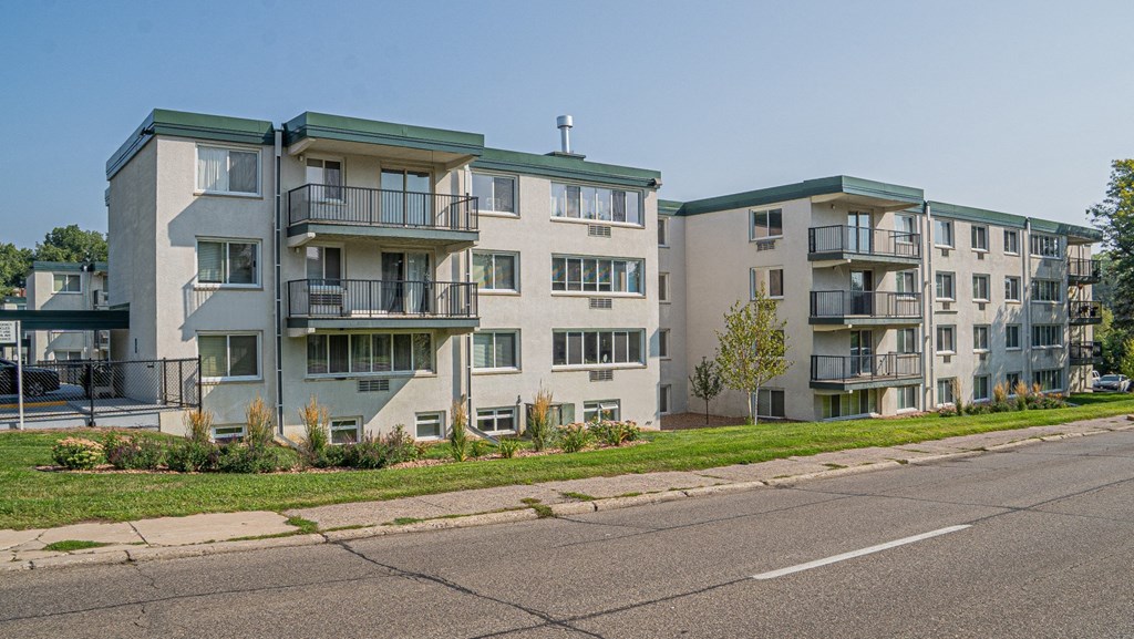 an image of an apartment building on the side of a street