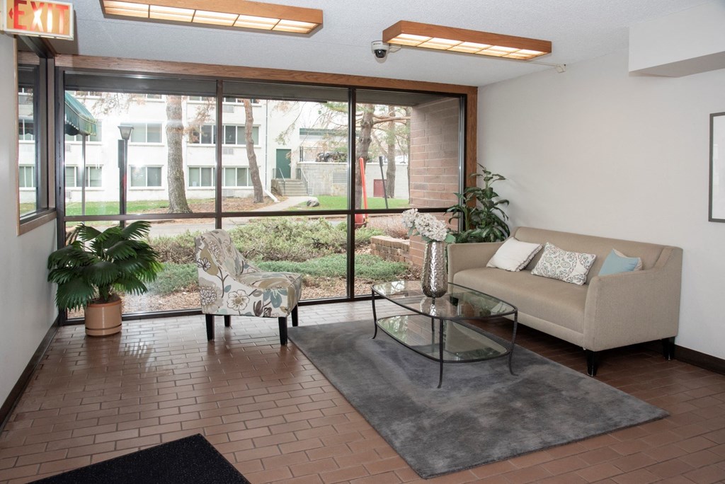 a living room with a couch and a glass table