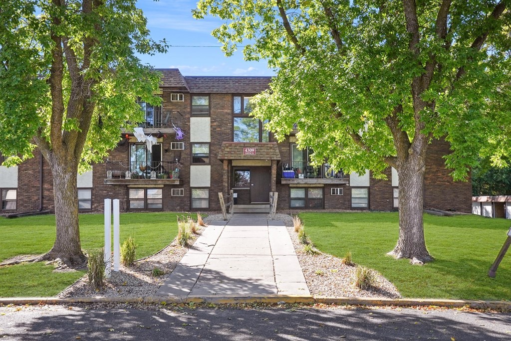 a large brick building with trees in front of it