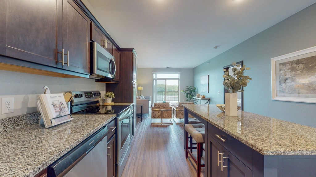 a kitchen with granite countertops and stainless steel appliances at Lake Jonathan Flats, Minnesota, 55318