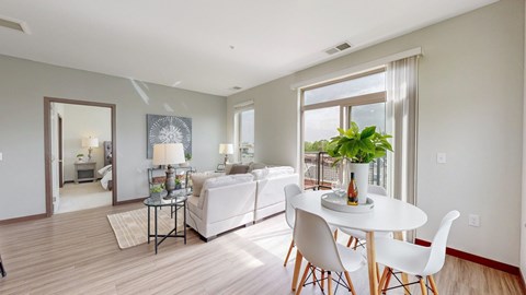 A dining room with a white table and chairs.