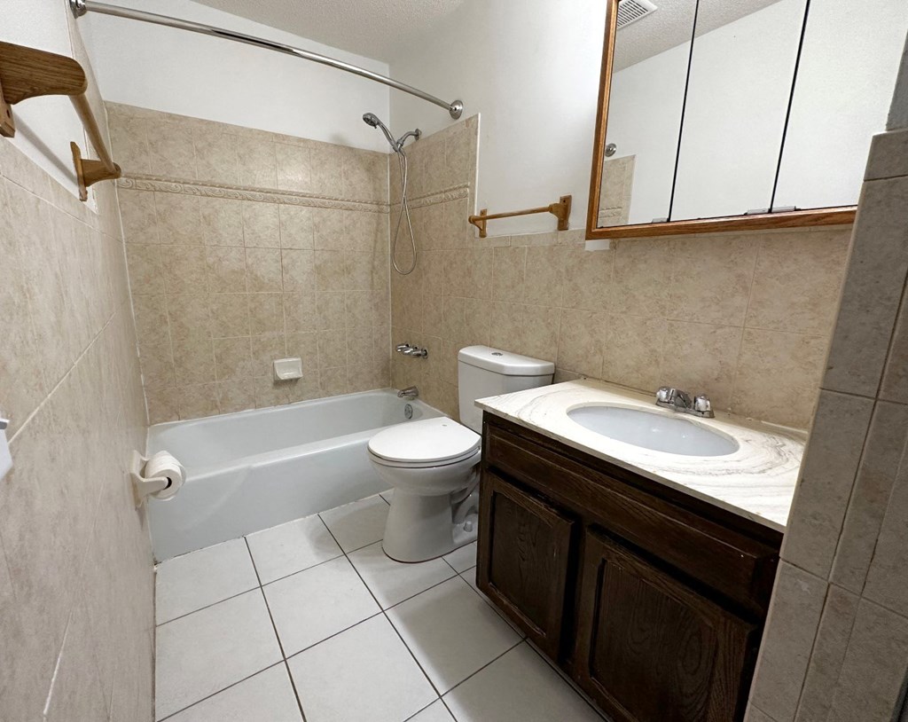 a bathroom with a toilet and a sink and a bath tub