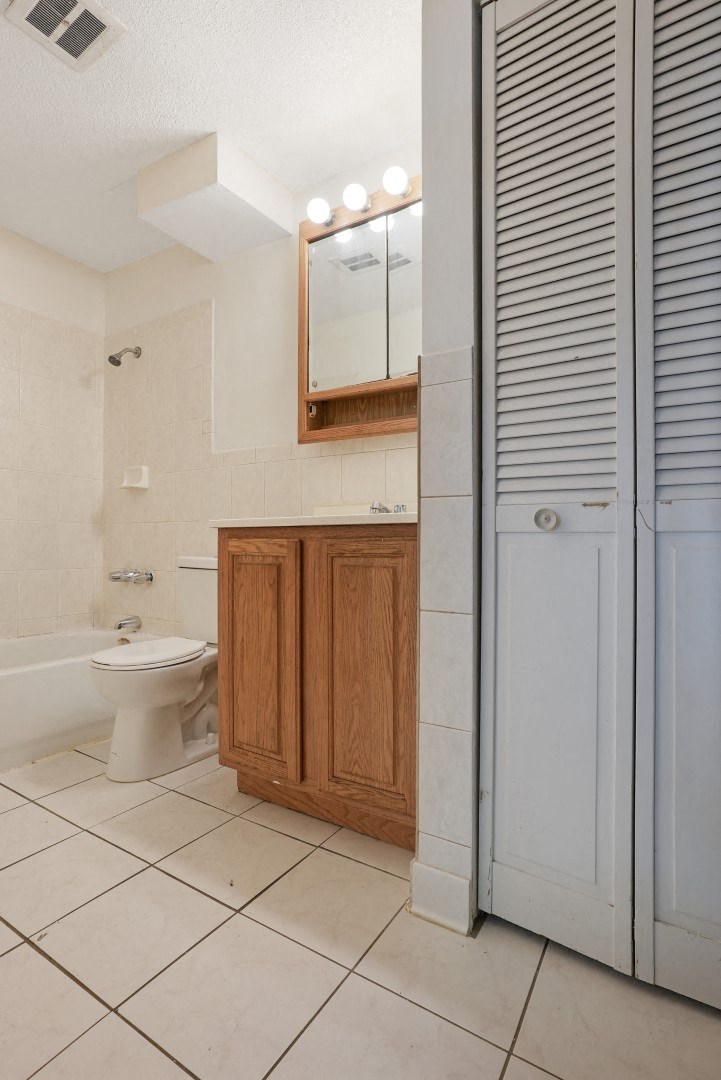 a bathroom with a toilet and a sink and a shower