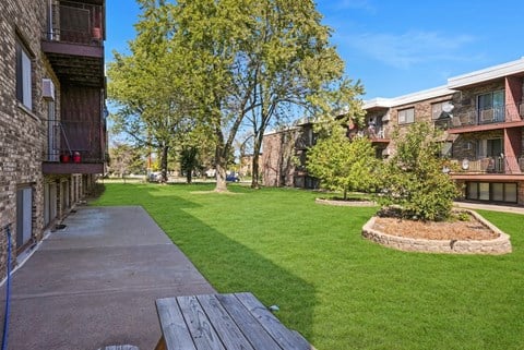 our apartments have a spacious courtyard with grass and trees