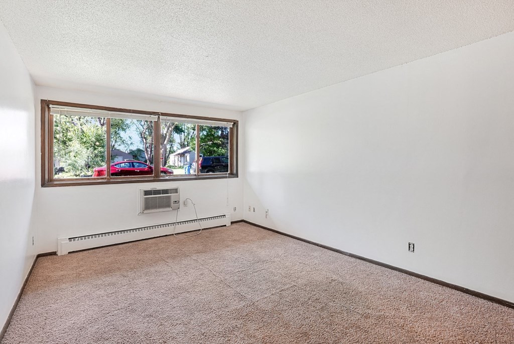 the living room of a house with a large window