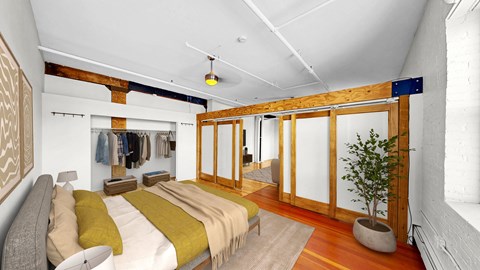 A bedroom with a bed and a potted plant.