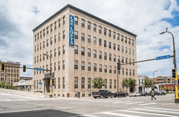 A large building with a blue sign on the side of it.