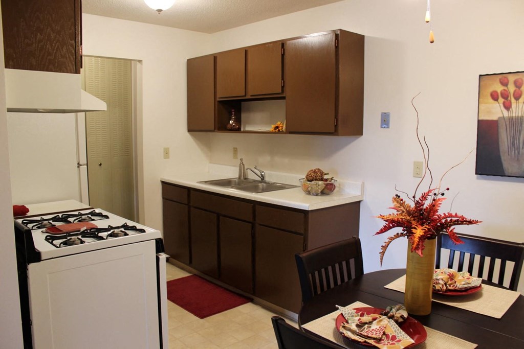 a kitchen and dining room with a table and chairs