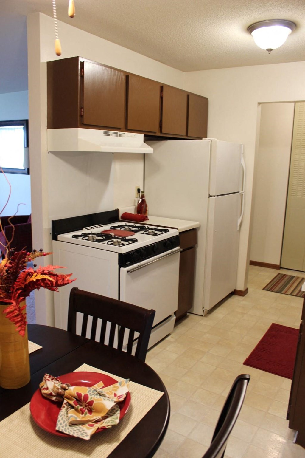 a kitchen with a dining table and a white refrigerator