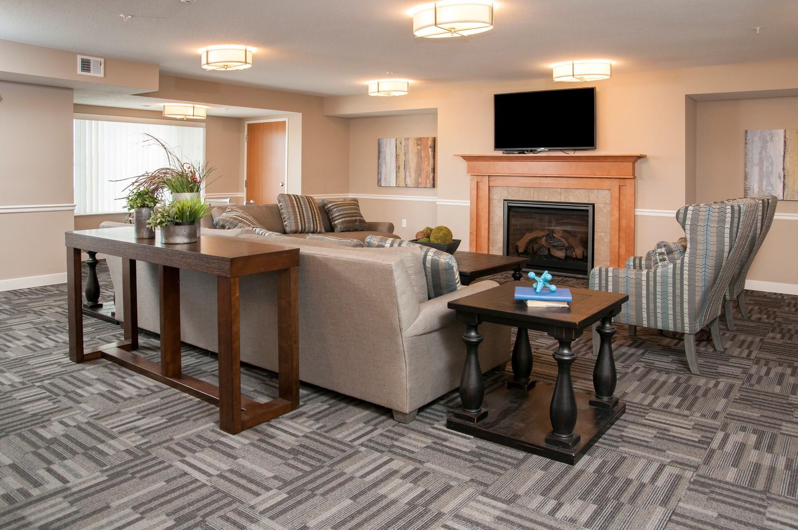 Community Room with Flat screen Television, Comfortable seeing area and Fireplace at Carver Crossing