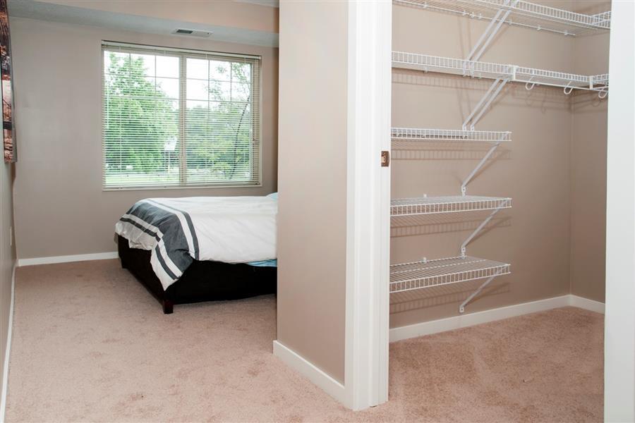 Walk-in Closet Connected to Master Bedroom with Built in Storage Racks at Carver Crossing