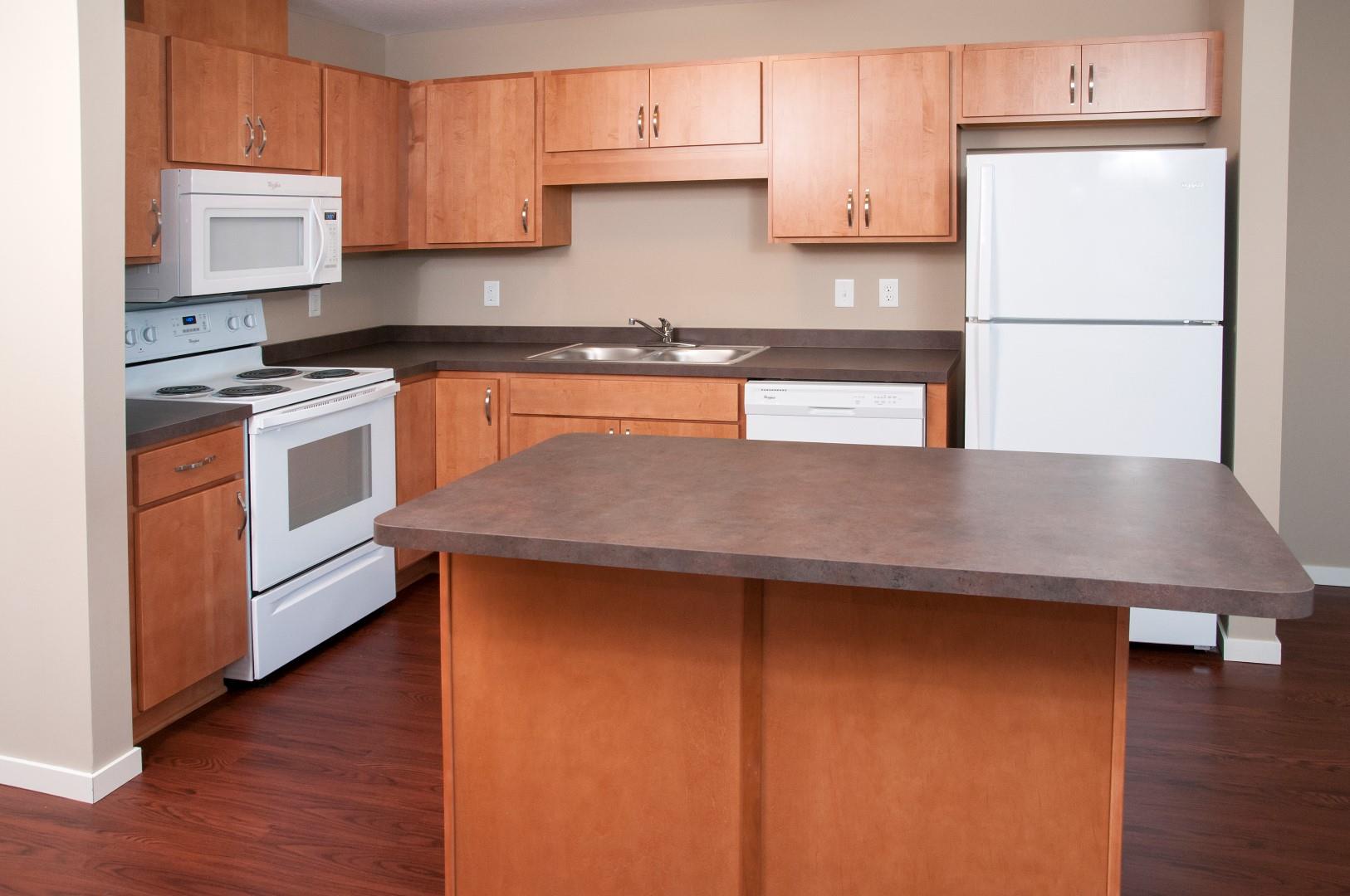 Carver Crossing Kitchen with White Appliances and Wood Cabinetry