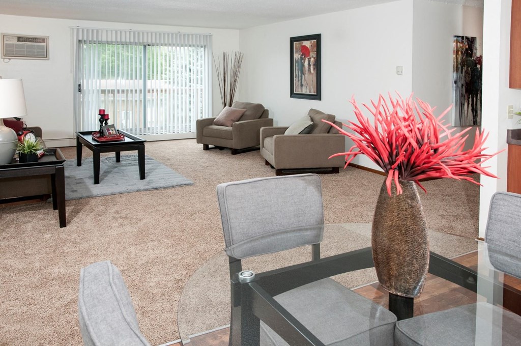 a living room with couches and chairs and a glass table