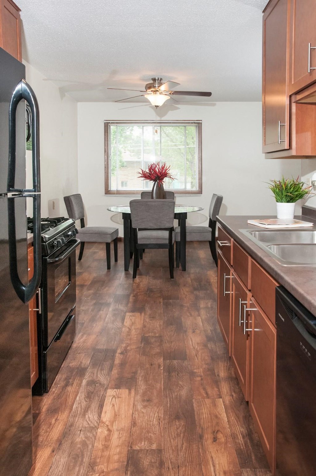 a kitchen and dining room with a table and chairs