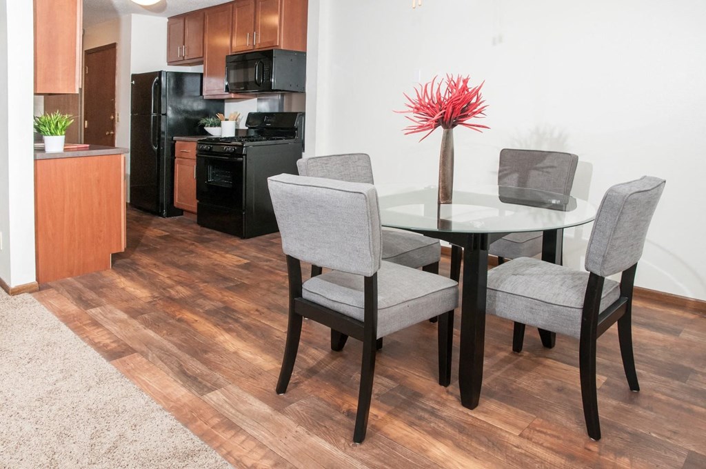 a dining room with a table and chairs