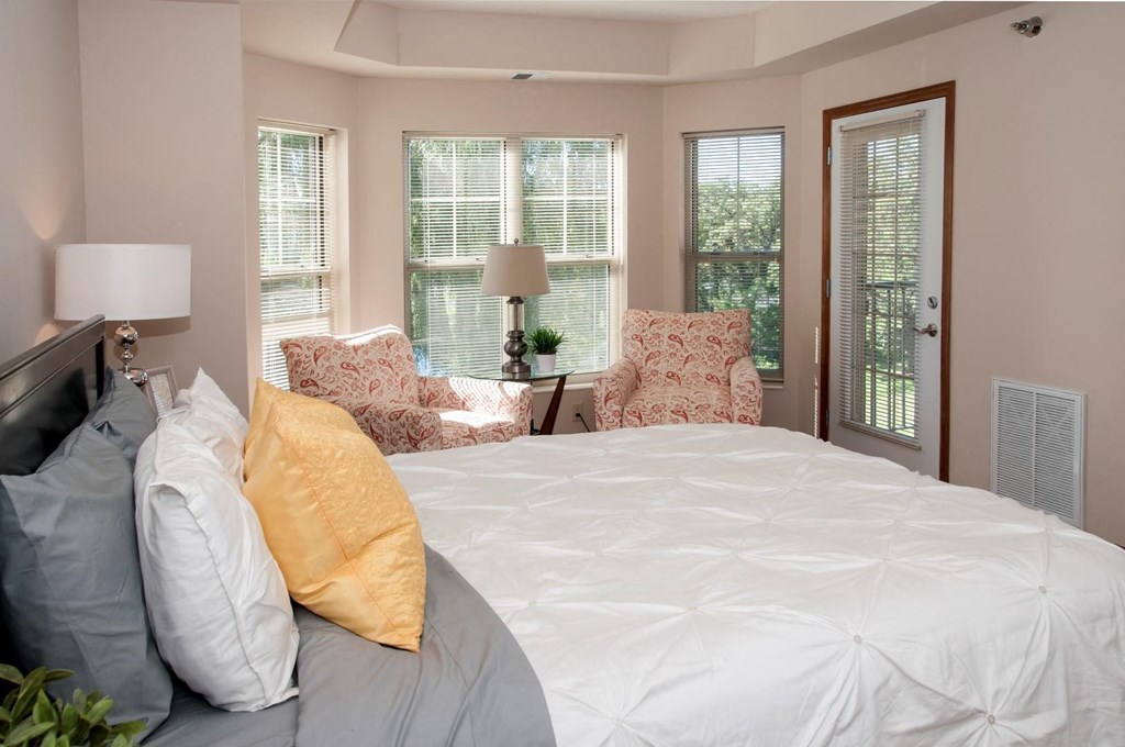master bedroom with bay windows and patio