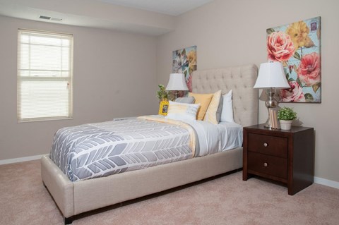 a bedroom with a bed and a dresser
