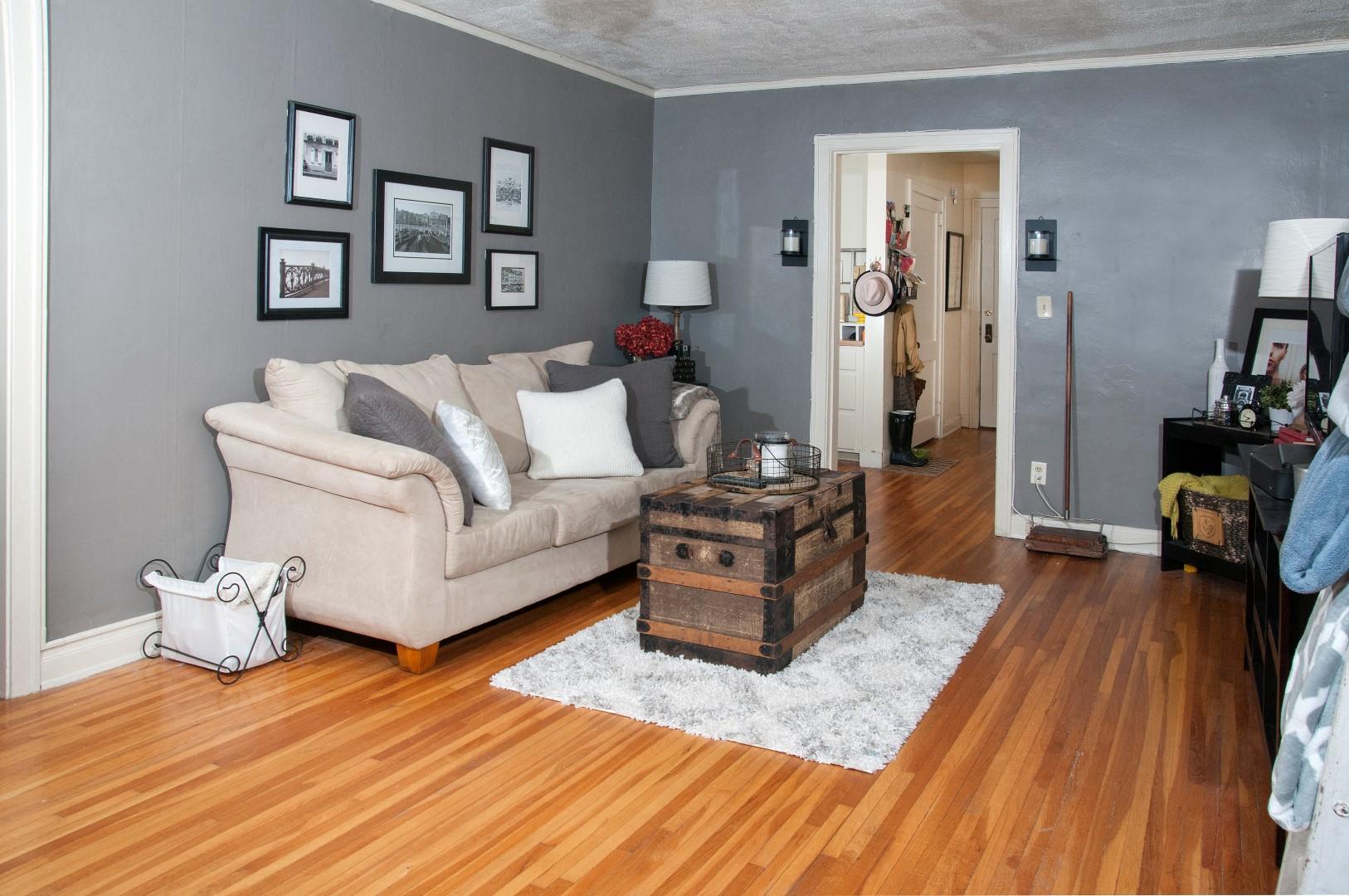 a living room with a couch and a chest in the middle