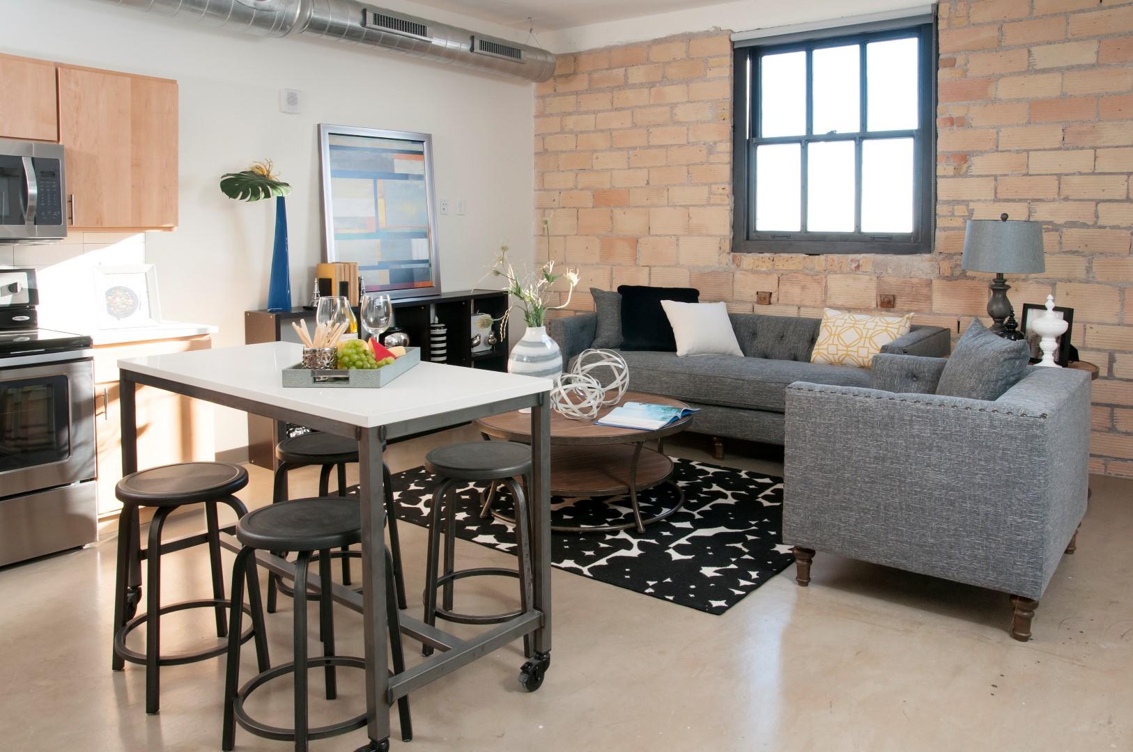 Exposed Brick Wall in Living Room at 700 Central Apartment Unit