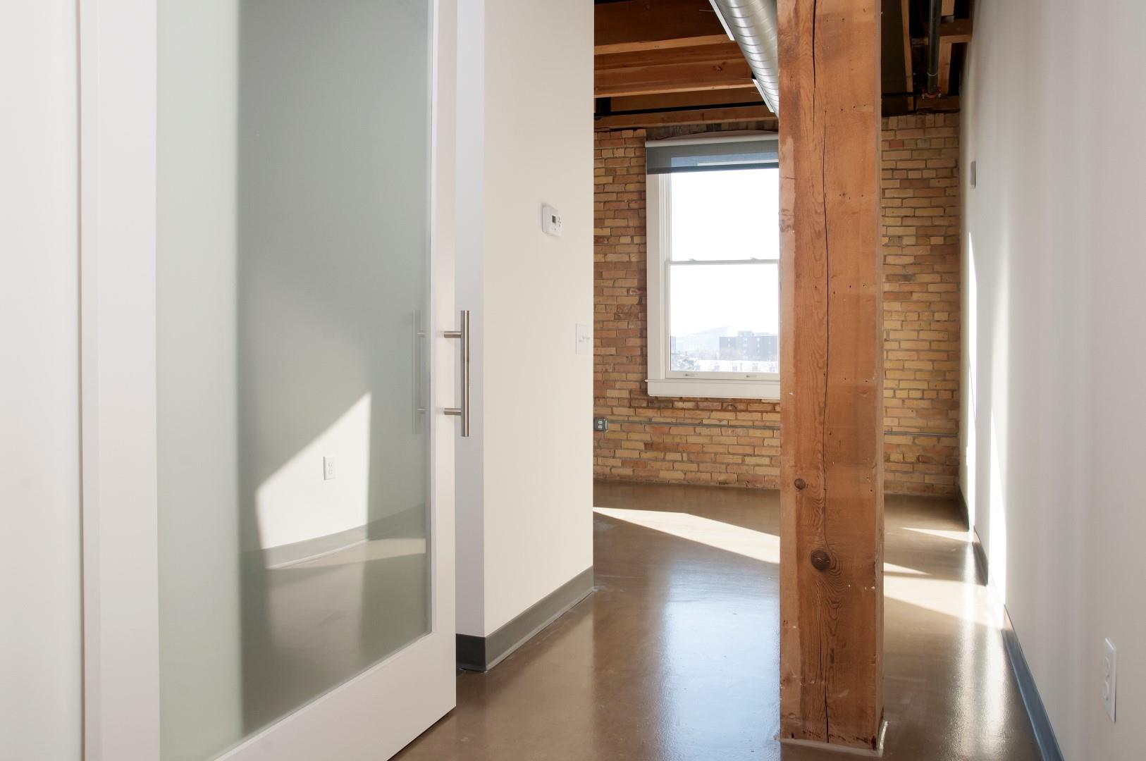 Translucent Sliding Door with White Frame to Entrance of Master Bedroom at Minneapolis MN Apartment