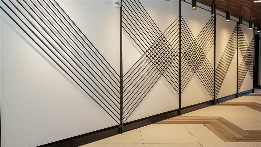 A wall with a black and white geometric design at The Bessemer at Seward Commons Apartments, MN, 55404