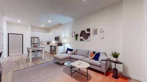 A modern living room with a grey sofa and a coffee table.