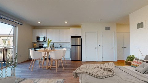 A modern kitchen with a dining table and chairs.